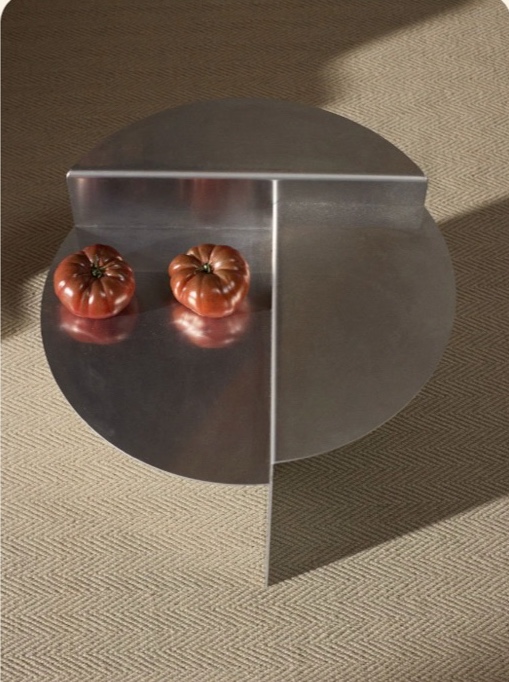 Sculptural steel side table with two tomatoes in Simona's living room